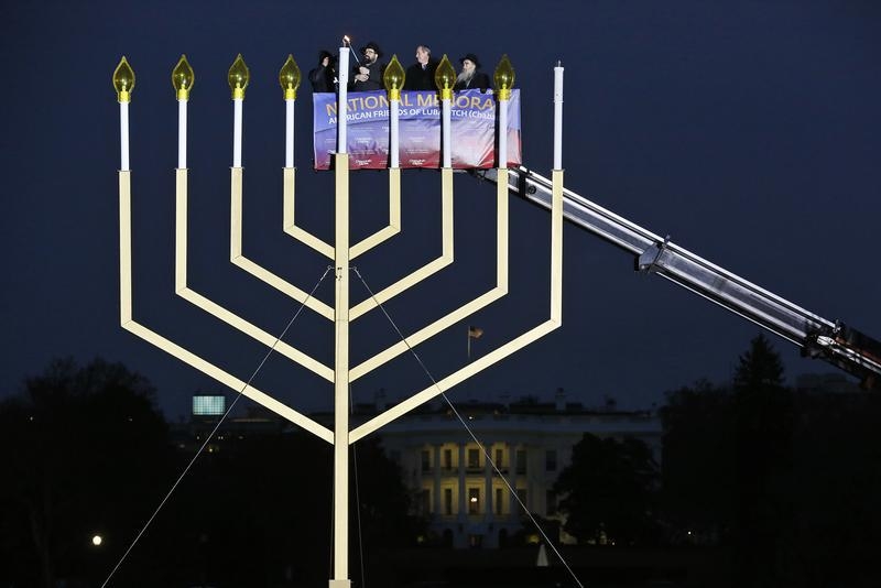 FILE - Rabbi Levi Shemtov (2nd L), executive vice president of American Friends of Lubavitch (Chabad), lights the U.S. National Chanukah (Hanukkah) Menorah in front of the White House with in Washington, November 27, 2013. REUTERS