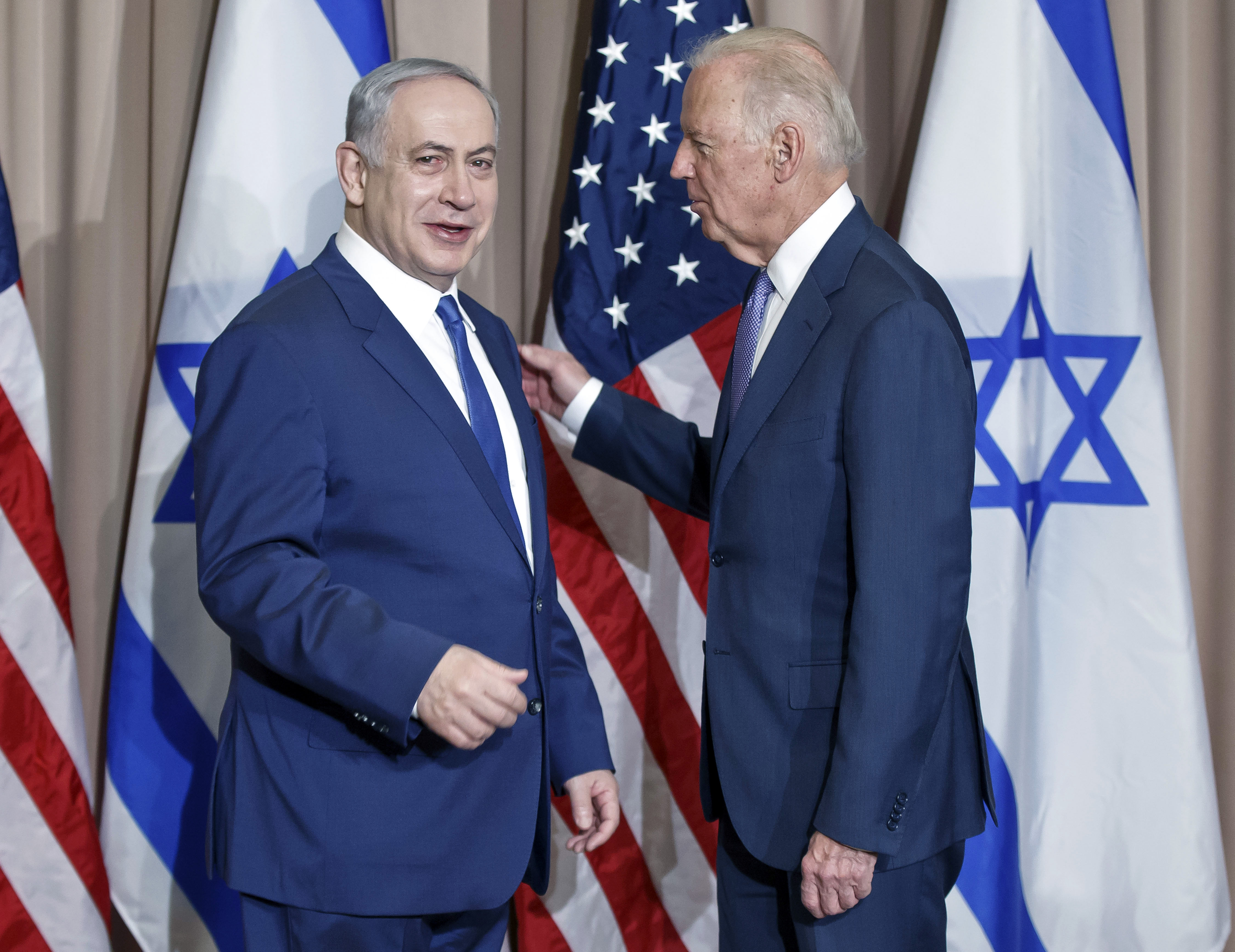 Israeli Prime Minister Benjamin Netanyahu, left, and US Vice-President Joe Biden pose for the media prior to a meeting on the sidelines of the World Economic Forum in Davos, Switzerland, Thursday, Jan. 21, 2016. The meeting comes less than a week after a diplomatic breakthrough between the U.S. and Iran that has put Israel's government on edge.(AP Photo/Michel Euler)