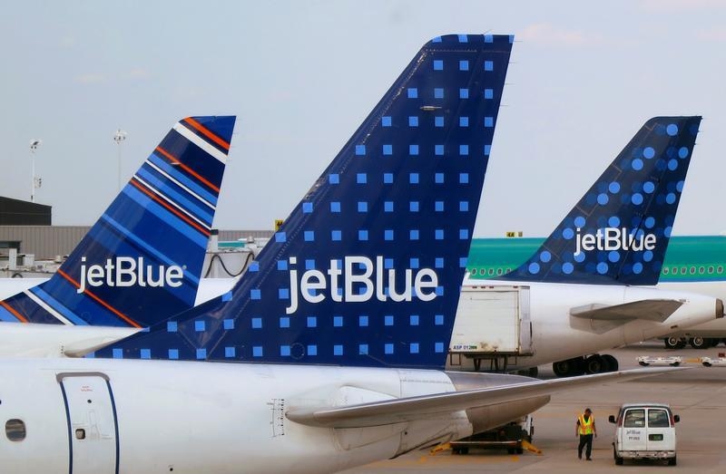 FILE - JetBlue Airways aircrafts are pictured at departure gates at John F. Kennedy International Airport in New York June 15, 2013. REUTERS/Fred Prouser/File Photo
