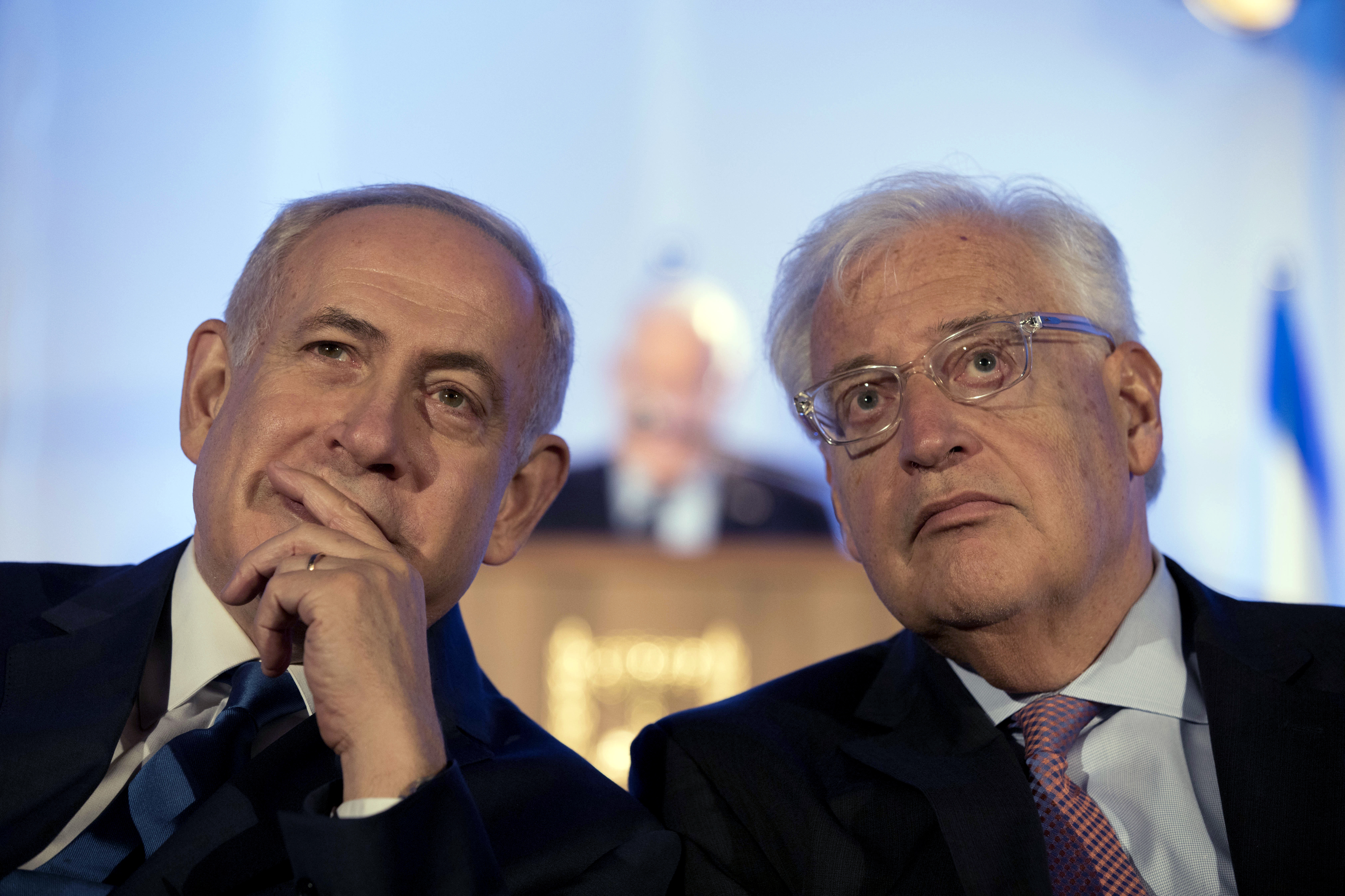 FILE - In this May 21, 2017, file photo, Israeli Prime Minister Benjamin Netanyahu, left and David Friedman, right, the new United States Ambassador to Israel attend a ceremony celebrating the 50th anniversary of the liberation and unification of Jerusalem, in front of the walls of the Old City of Jerusalem. AP sources say President Donald Trump is considering giving Friedman more authority over the U.S. outpost that handles Palestinian affairs, a shift likely to further dampen Palestinian hopes for an independent state. (Abir Sultan/Pool Photo via AP, File)