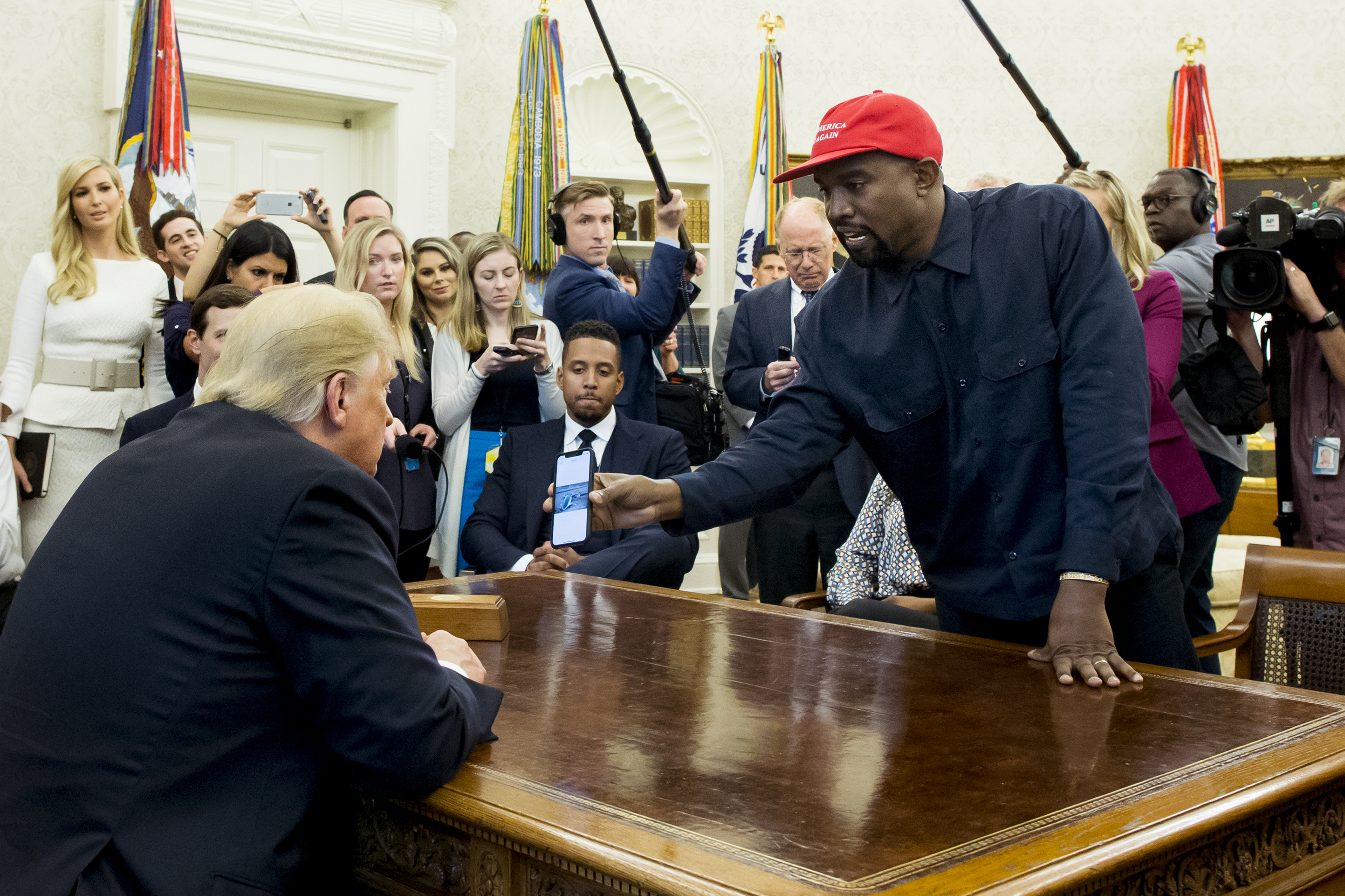 FILE - US entertainer Kanye West (R) shows a cell phone depicting the image of an aircraft to US President Donald J. Trump (L) during their meeting in the Oval Office of the White House in Washington, DC, USA, 11 October 2018. EPA