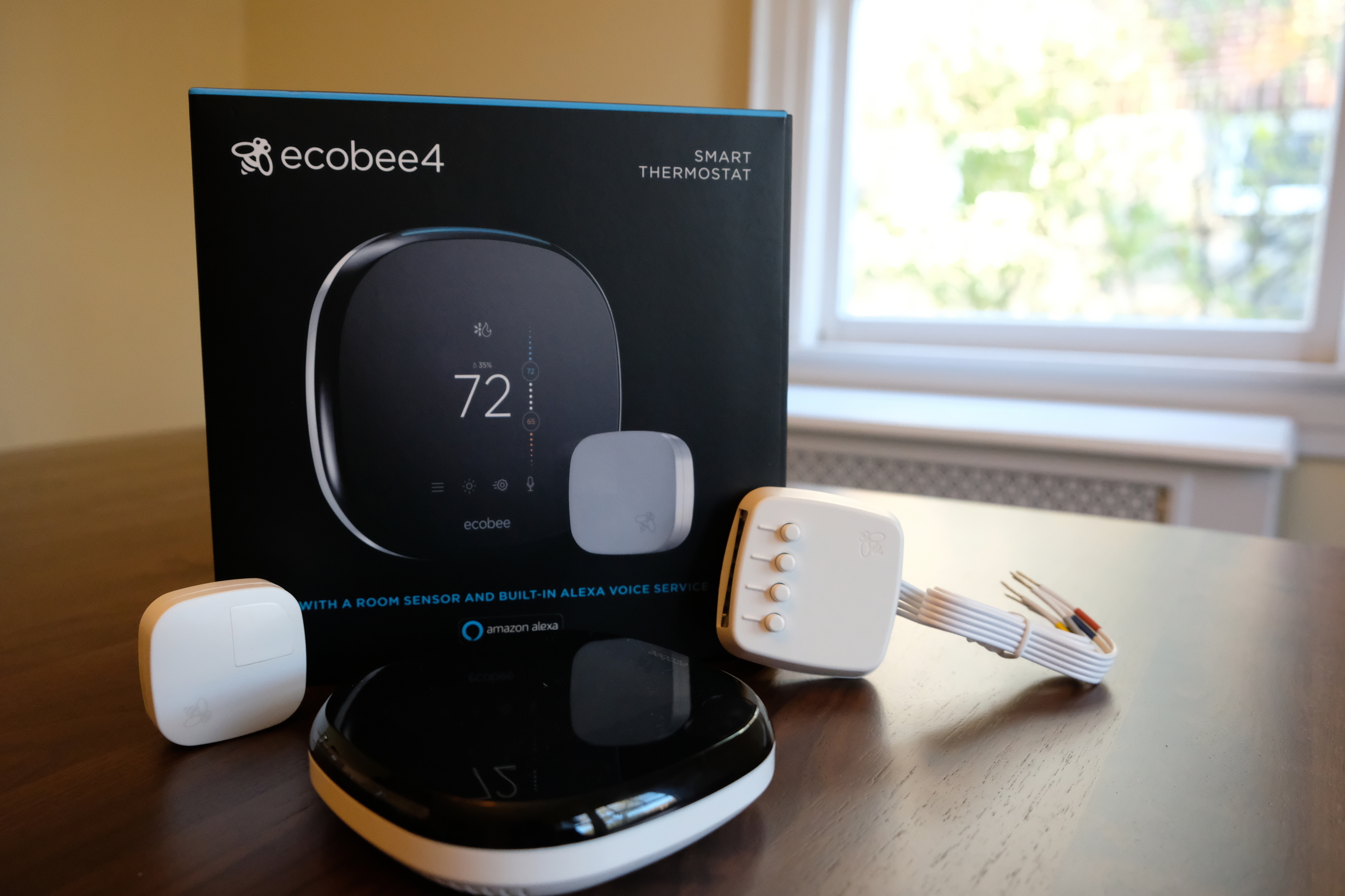 FILE - This Nov. 11, 2018, photo shows an Ecobee smart thermostat, room sensor and connection components in Hastings-on-Hudson, N.Y. Smart thermostats, which let consumers adjust their home temperatures remotely using any internet-connected device, are among the most popular smart home technologies, with the global smart thermostat market surpassing $1 billion in 2017, according to Research and Markets. (AP Photo/Cathy Bussewitz, File)