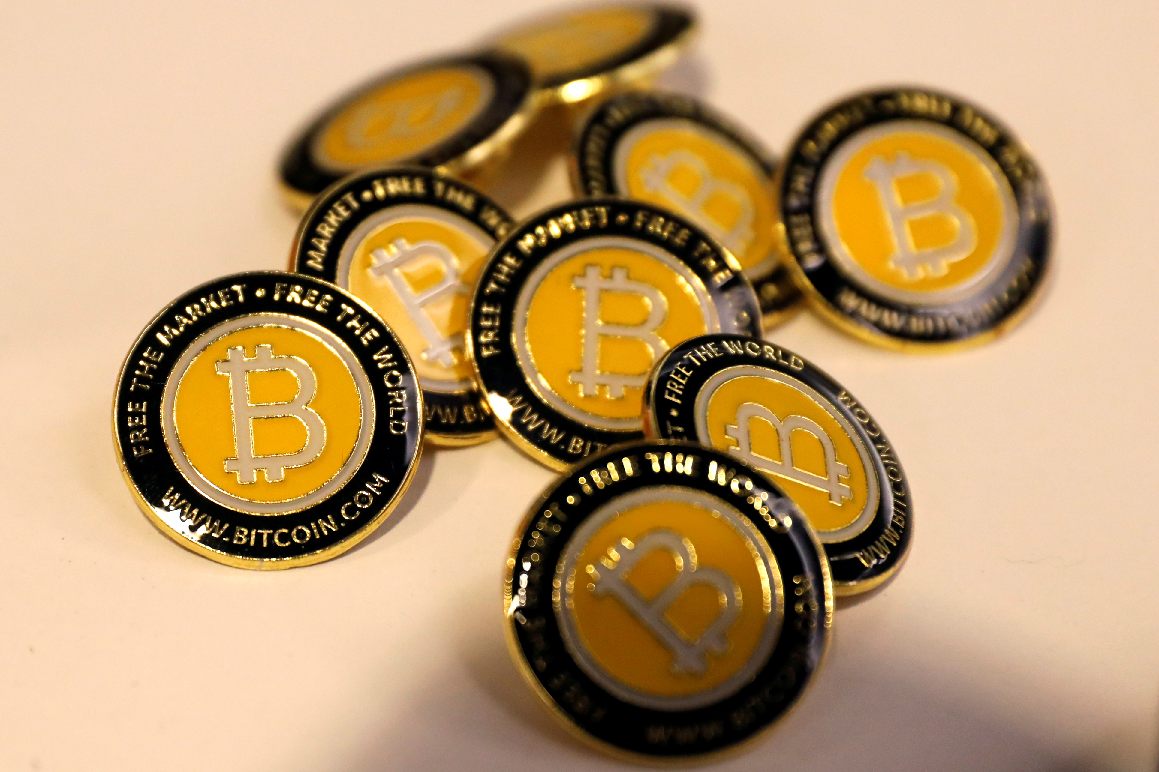FILE - Bitcoin.com buttons are seen displayed on the floor of the Consensus 2018 blockchain technology conference in New York City, New York, U.S., May 16, 2018. REUTERS/Mike Segar/File Photo