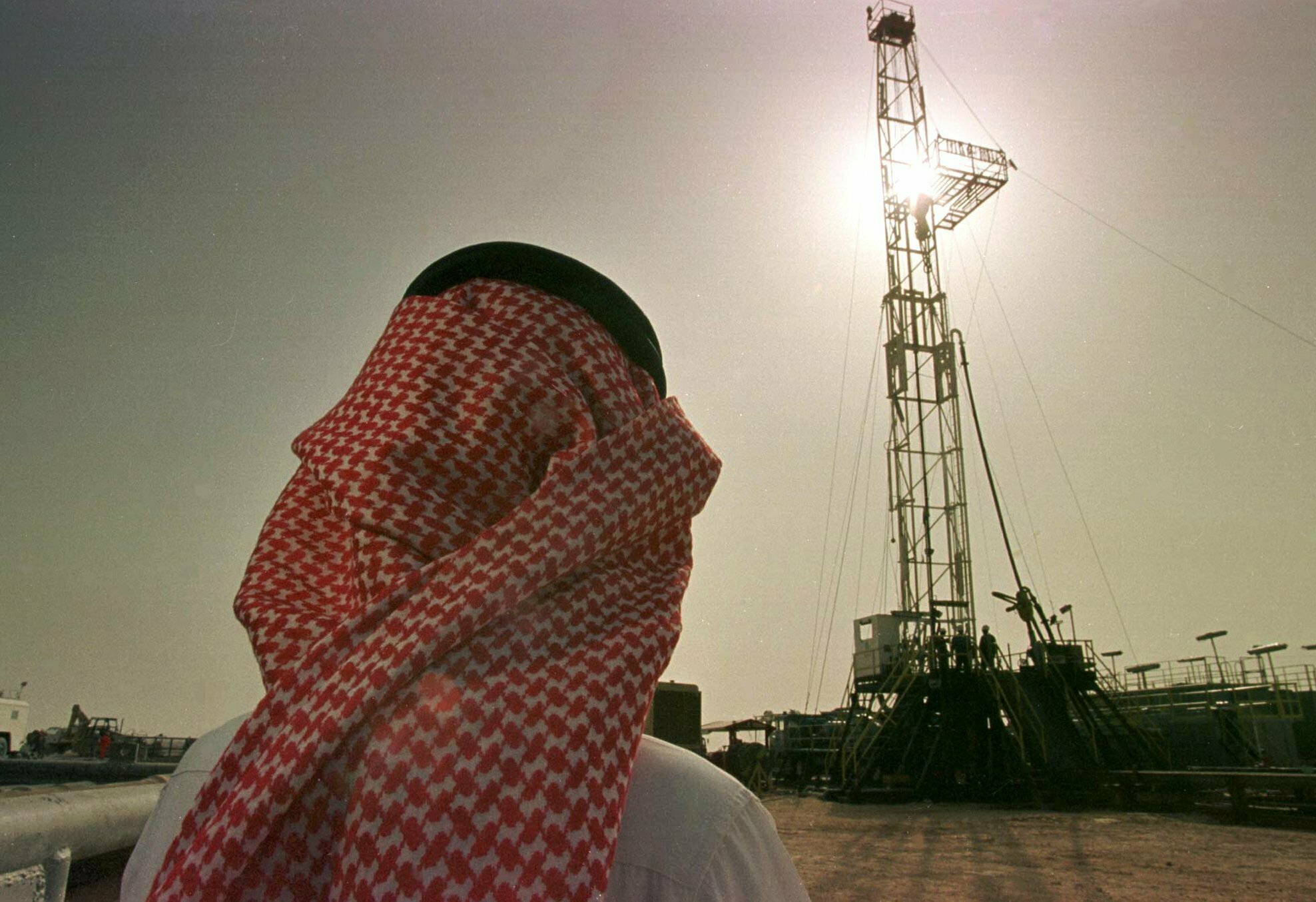 FILE - In this Feb. 26, 1997 file photo, Khaled al-Otaiby, an official of the Saudi oil company Aramco, watches progress at a rig at the al-Howta oil field near Howta, Saudi Arabia. According to an assessment published Monday, April 1, 2019, by Moody's Investors Services, the net profits of Saudi Aramco reached $111 billion last year. (AP Photo/John Moore, File)