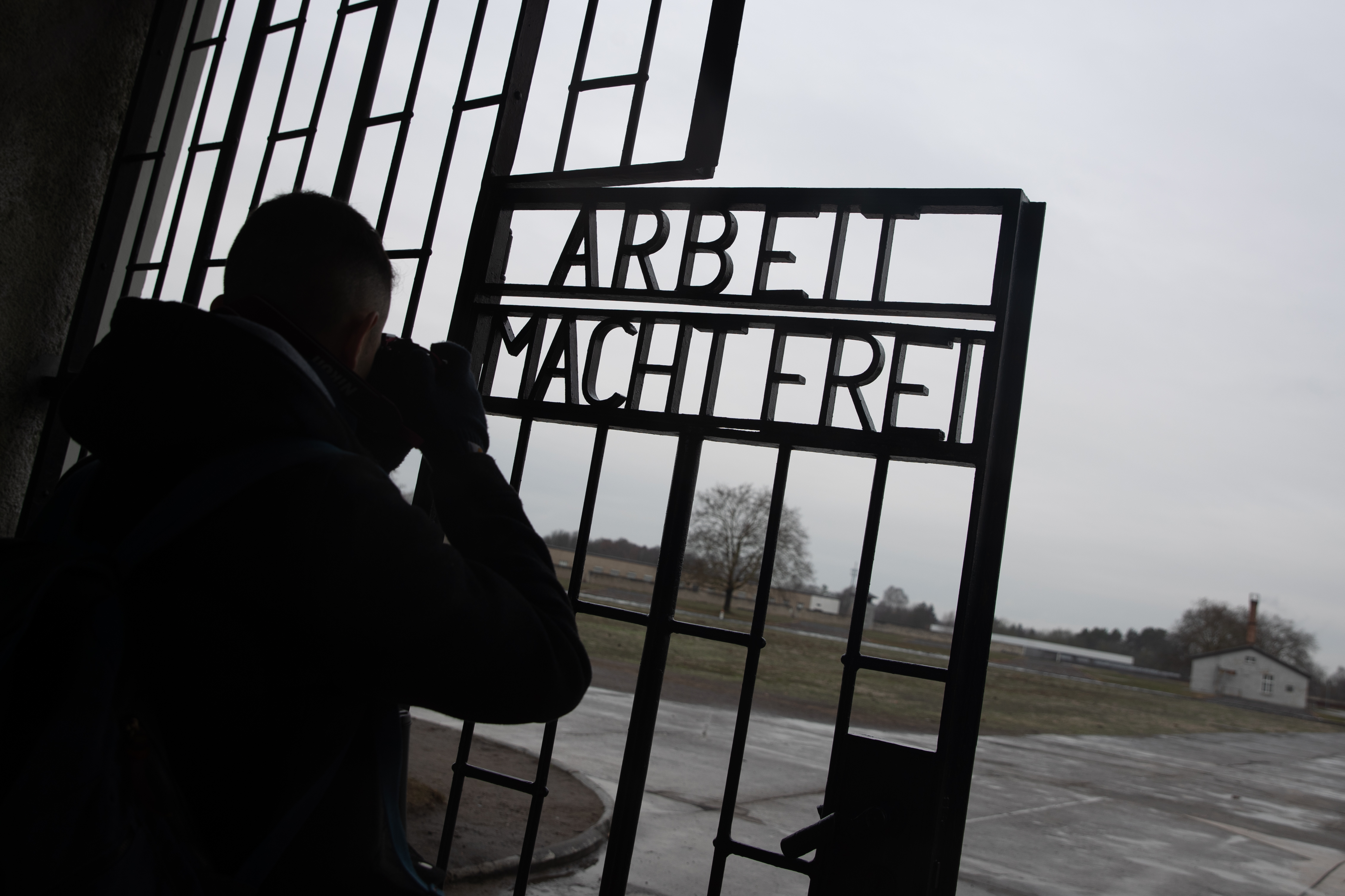 FILE - A student from Britain takes pictures of the sentence 'Work sets you free' (Arbeit macht frei) at the main entrance door at the Sachsenhausen concentration camp site in Oranienburg, Germany, 27 January 2019. EPA