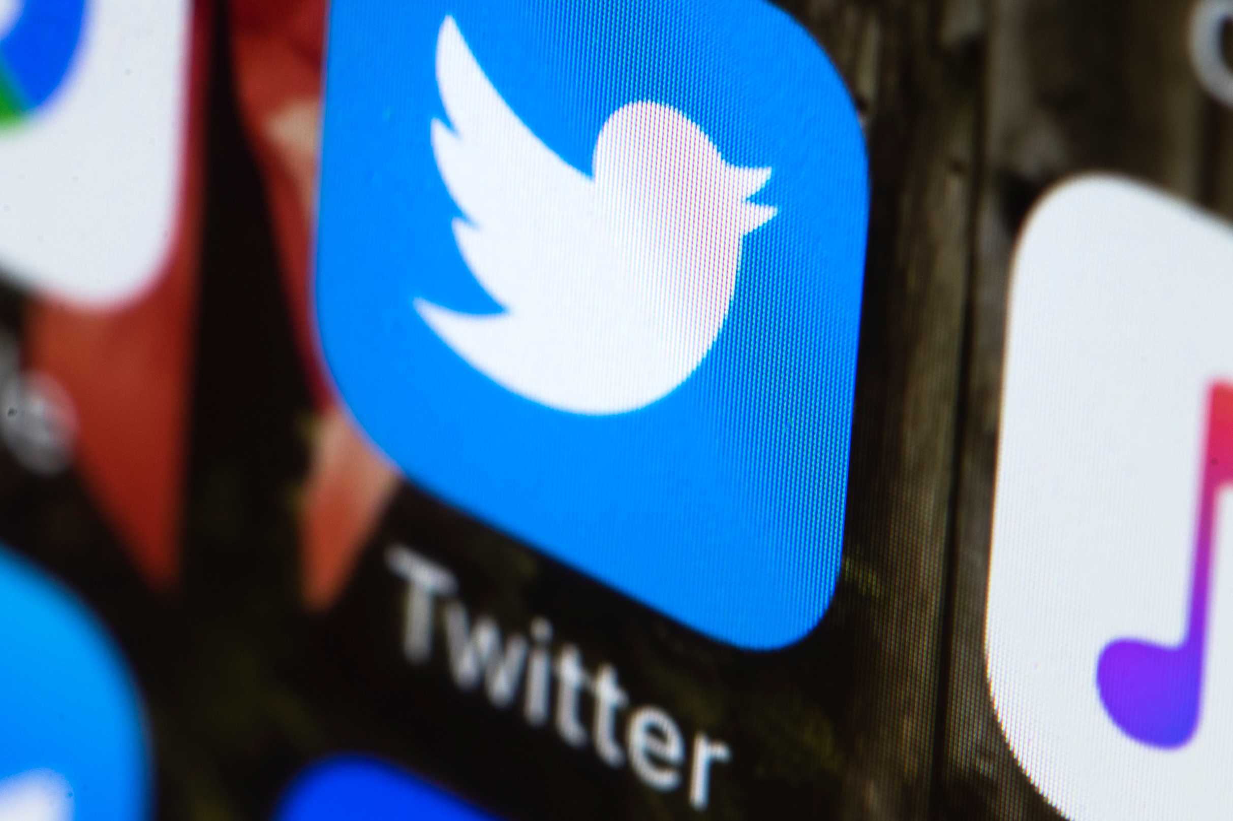 FILE - This April 26, 2017, file photo shows the Twitter app on a mobile phone in Philadelphia. Twitter will now prohibit hate speech that targets religious groups using dehumanizing language. AP Photo/Matt Rourke, File)