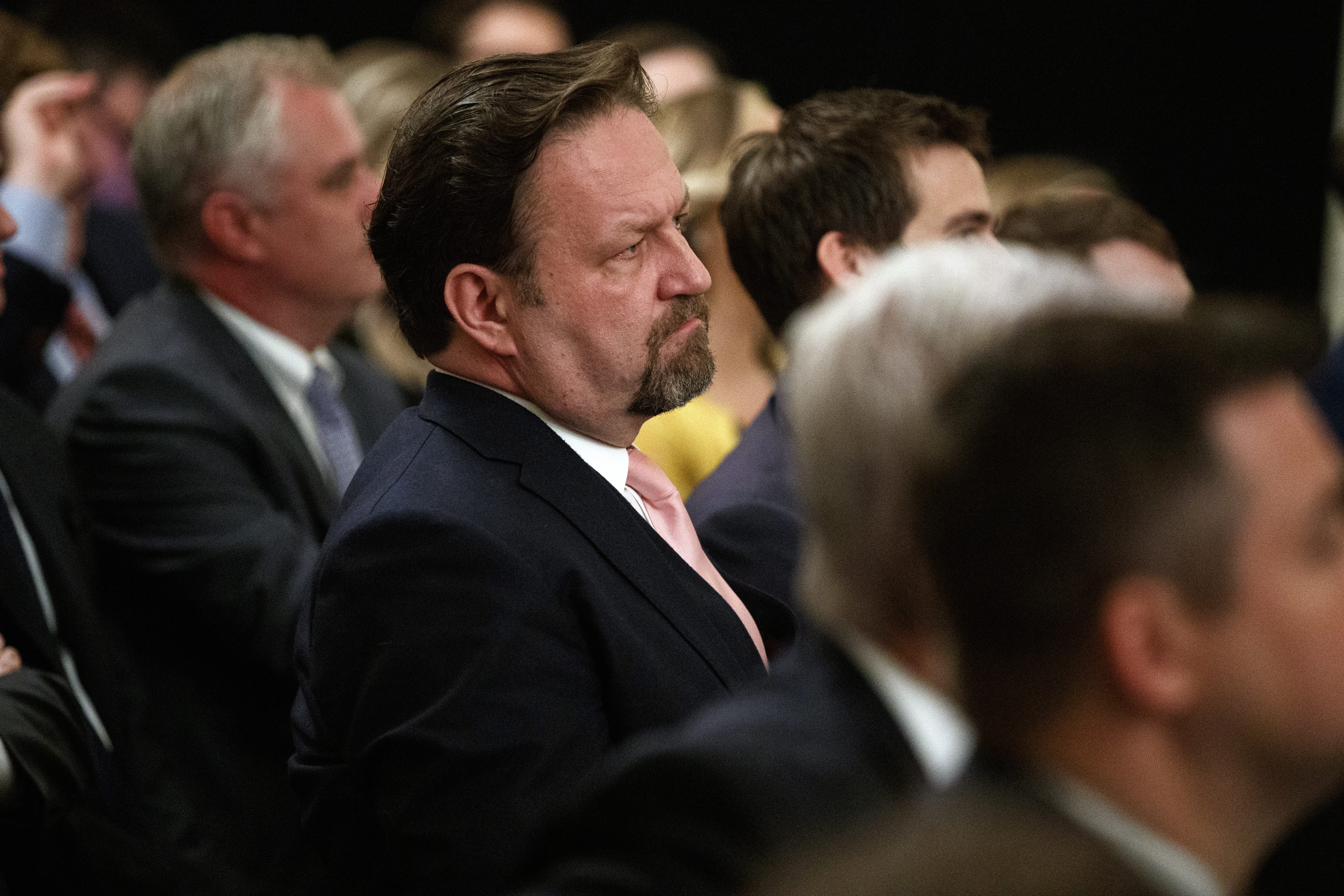 Radio host Seb Gorka listens as President Donald Trump speaks during the "Presidential Social Media Summit" in the East Room of the White House, Thursday, July 11, 2019, in Washington. (AP Photo/Evan Vucci)