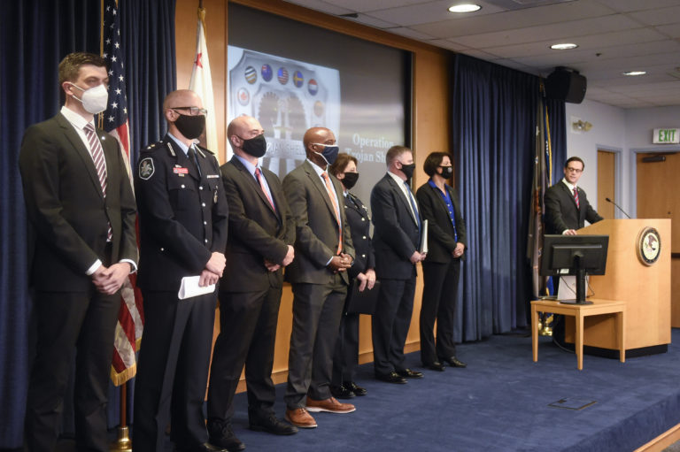Acting U.S Attorney Randy Grossman, right, speaks as law enforcement officials look on during a news conference announcing Operation Trojan shield, Tuesday, June 8, 2021, in San Diego. The global sting operation involved an encrypted communications platform developed by the FBI and has sparked a series of raids and arrests around the world in which more than 800 suspects were arrested and more than 32 tons of drugs — cocaine, cannabis, amphetamines and methamphetamines were seized. (AP Photo/Denis Poroy)