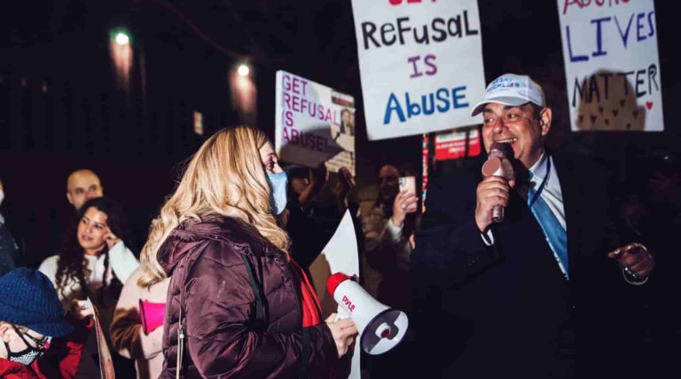 Amber Adler, left, and Heshy Tischler, candidates for New York City Council, attend a rally in Brooklyn, March 21, 2021. The rally was part of a movement to free a woman whose husband refused to grant her a Jewish divorce. (Anna Rathkopf)