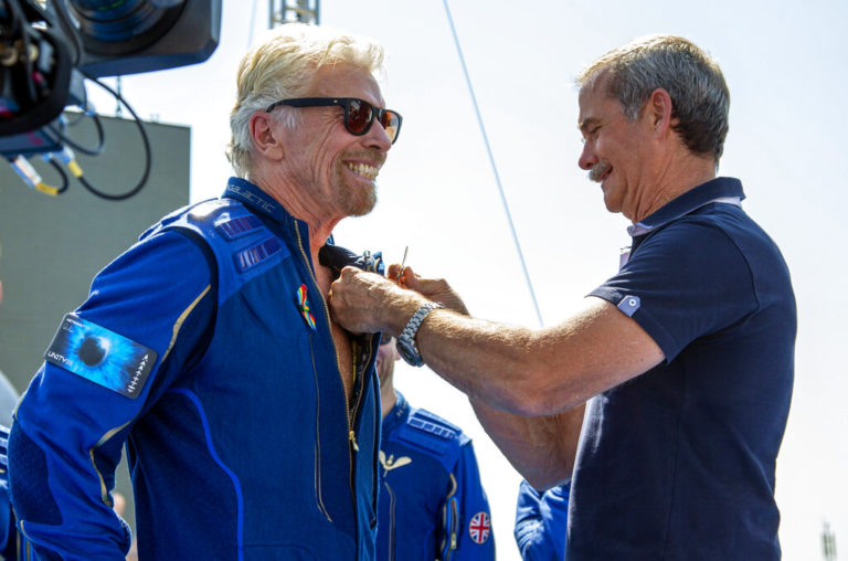 Virgin Galactic founder Richard Branson, left, receives a Virgin Galactic made astronaut wings pin from Canadian astronaut Chris Hadfield after his flight to space from Spaceport America near Truth or Consequences, N.M., Sunday, July 11, 2021. (AP Photo/Andres Leighton)
