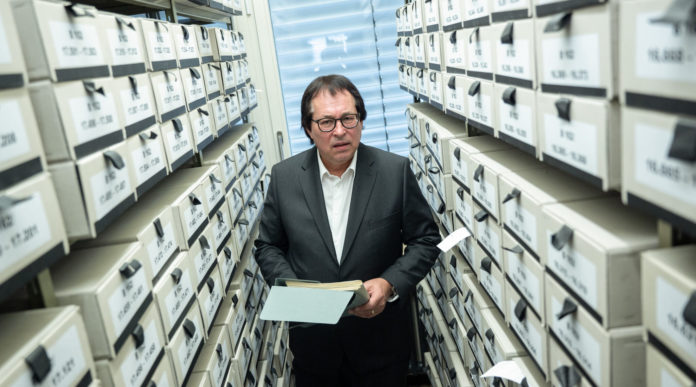 Thomas Will, head of the Central Office for the Investigation of National Socialist Crimes, stands among the office's files in Ludwigsburg, Germany, Feb. 18, 2021.
