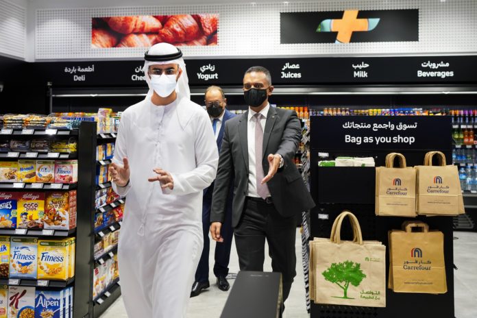 From left, Emirati Minister of State for Artificial Intelligence Omar Sultan al-Olama, Majid Al Futtaim CEO Alain Bejjani and Majid Al Futtaim Retail CEO Hani Weiss leave Carrefour's new cashier-less grocery store in Mall of the Emirates in Dubai, United Arab Emirates, Monday, Sept. 6, 2021. The Middle East on Monday got its first completely automated cashier-less store, as retail giant Carrefour rolled out its vision for the future of the industry in a cavernous Dubai mall. (AP Photo/Isabel DeBre)