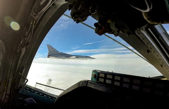 In this handout photo taken from video released by Russian Defense Ministry Press Service on Wednesday, Nov. 10, 2021, a long-range Tu-22M3 bomber of the Russian Aerospace Forces flies to patrol in the airspace of Belarus, Thursday, Nov. 11, 2021. Russia has sent two nuclear-capable strategic bombers on a training mission over Belarus in a show of Moscow's support for its ally amid a dispute over migration at the Polish border. Russia has supported Belarus amid a tense standoff this week as thousands of migrants gathered on the Belarus-Poland border in hopes of crossing into Europe. (Russian Defense Ministry Press Service via AP)