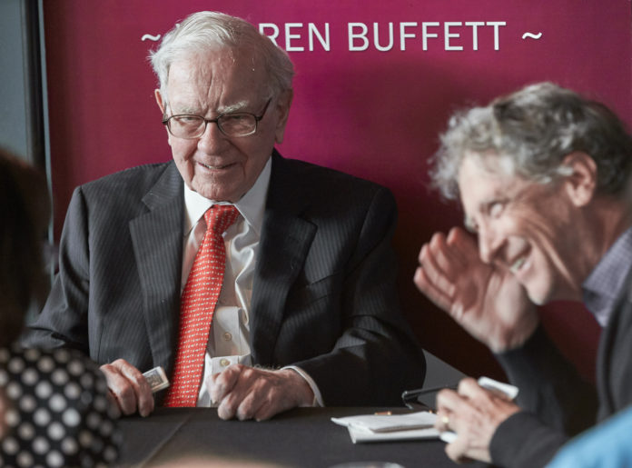 FILE - Warren Buffett, Chairman and CEO of Berkshire Hathaway, left, plays bridge following the annual Berkshire Hathaway shareholders meeting in Omaha, Neb., Sunday, May 5, 2019. Billionaire Buffett will release his annual letter to Berkshire Hathaway shareholders Saturday, Feb. 26, 2022. It is always well read in the business world because so many investors follow Buffett because of his incredibly successful track record over the decades and he has a knack for explaining complicated subjects in simple terms. (AP Photo/Nati Harnik, File)