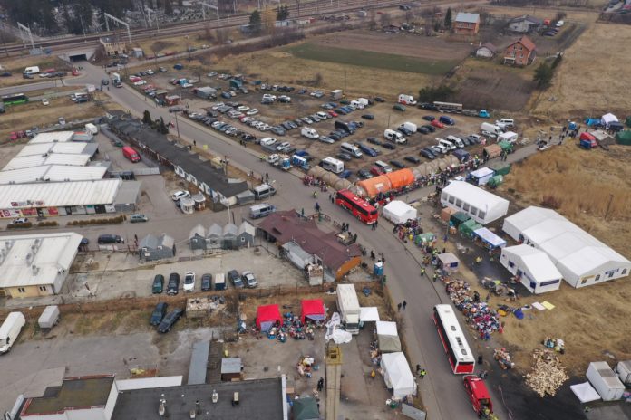 An aerial view of the border crossing at Medyka, Poland, Sunday March 13, 2022, where the main flow of Ukrainian refugees cross into Poland. The U.N. refugee agency says more than 2.5 million people, including more than a million children, have already fled Ukraine. It has become an unprecedented humanitarian crisis in Europe and the fastest refugee exodus since World War II. (AP Photo)