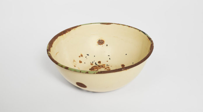 An enamel bowl, on display at the Museum of Jewish Heritage in Manhattan, was carried through three concentration camps by the Burbea family from Libya, even serving as a vessel to carry their youngest son to his circumcision when he was born in Bergen-Belsen in 1944. (Museum of Jewish Heritage)