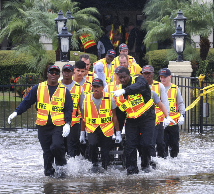 Rescuers evacuate residents from the Avante at Orlando assisted living facility on S.R. 436 in Orlando, Fla., due to flooding from Hurricane Ian, Thursday, Sept. 29, 2022. (Joe Burbank/Orlando Sentinel via AP)