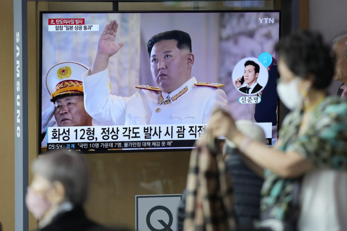 A TV screen showing a news program reporting about North Korea's missile launch with file footage of North Korean leader Kim Jong Un, is seen at the Seoul Railway Station in Seoul, South Korea, Tuesday, Oct. 4, 2022. North Korea on Tuesday fired an intermediate-range ballistic missile over Japan for the first time in five years, forcing Japan to issue evacuation notices and suspend trains, as the North escalates tests of weapons designed to strike regional U.S. allies. (AP Photo/Lee Jin-man)
