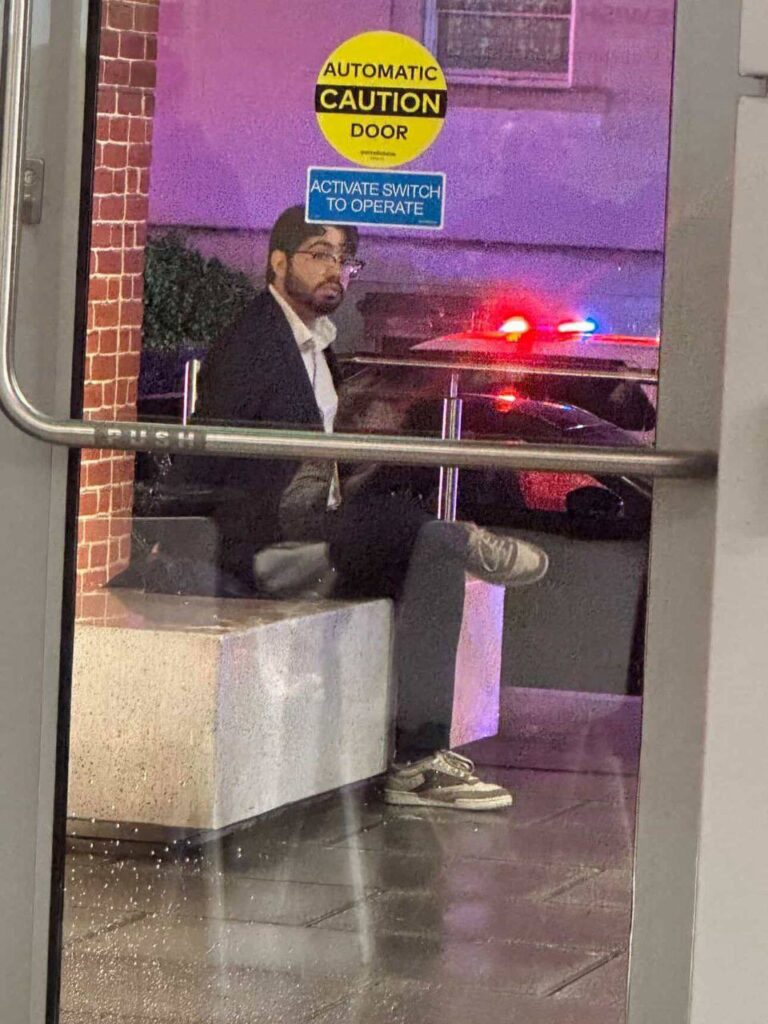 Elias Rodriguez waits for police after murdering Israeli diplomats
