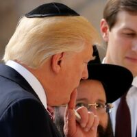 FILE - U.S. President Donald Trump holds a note in his hand as he and his son-in-law White House senior advisor Jared Kushner (R) prepare to leave notes at the Western Wall in Jerusalem May 22, 2017. REUTERS/Jonathan Ernst